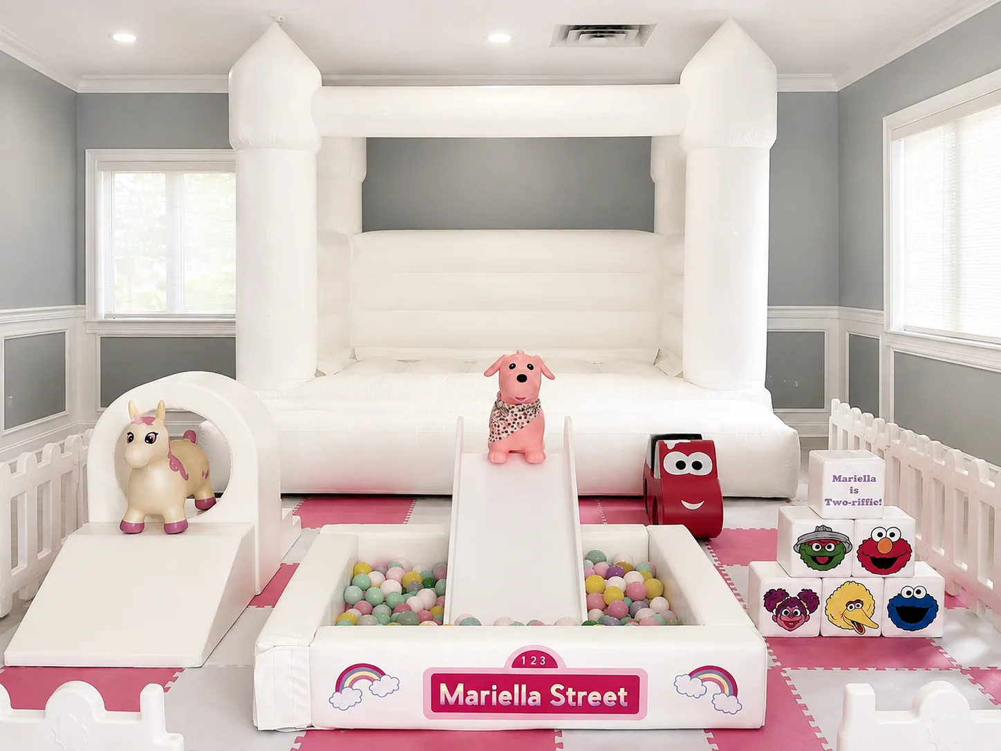Pink themed premium soft play setup with an XL white bounce house