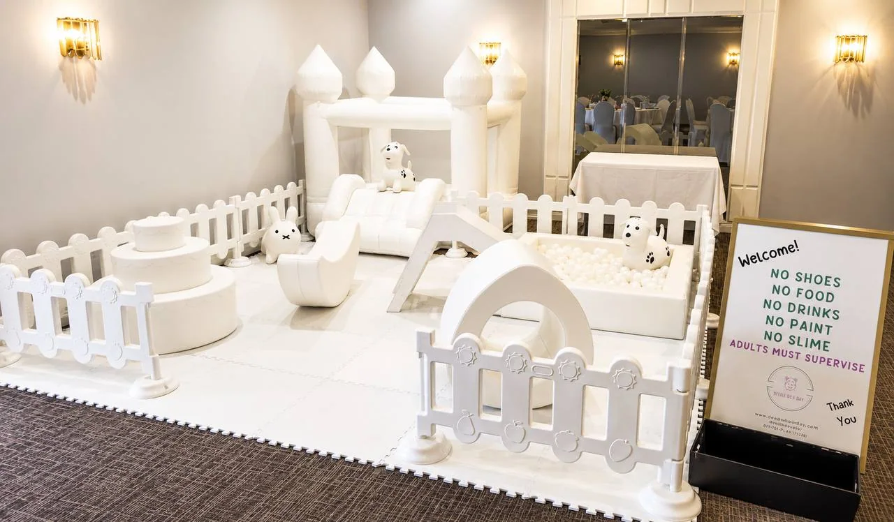 All-white premium soft play setup with a small bounce house